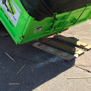 Dumpster Being Dropped on Boards